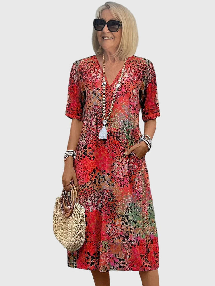 Stylish women's floral printed midi dress with a V-neck, ideal for spring & summer fashion. Boho flowy style.