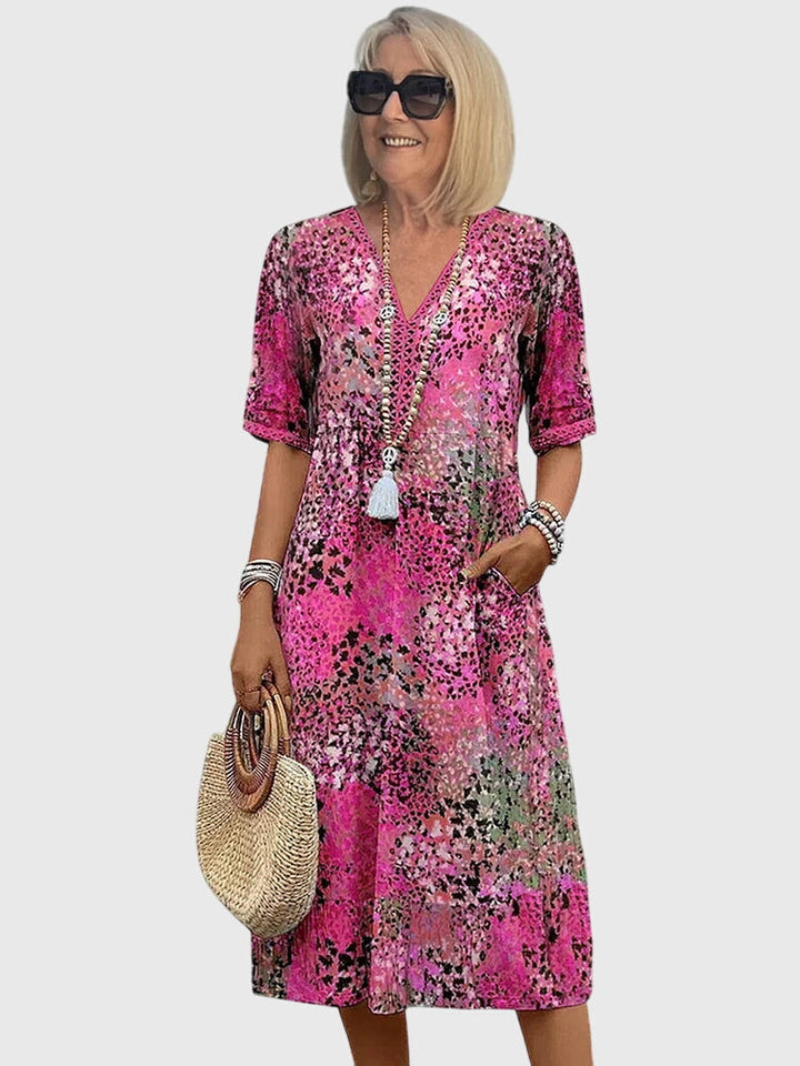 Elegant V-neck printed midi dress for women. Effortless summer apparel with a flowy, comfortable fit. Perfect casual.