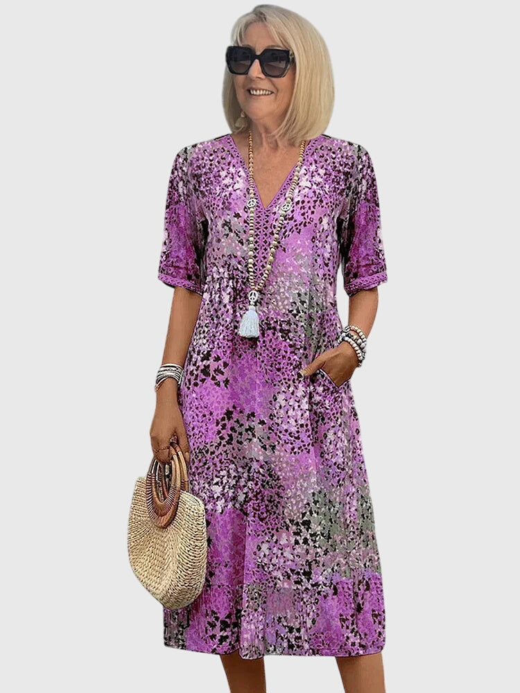 Boho style women's printed V-neck midi dress. Flowy design, perfect casual summer dress or spring fashion statement.