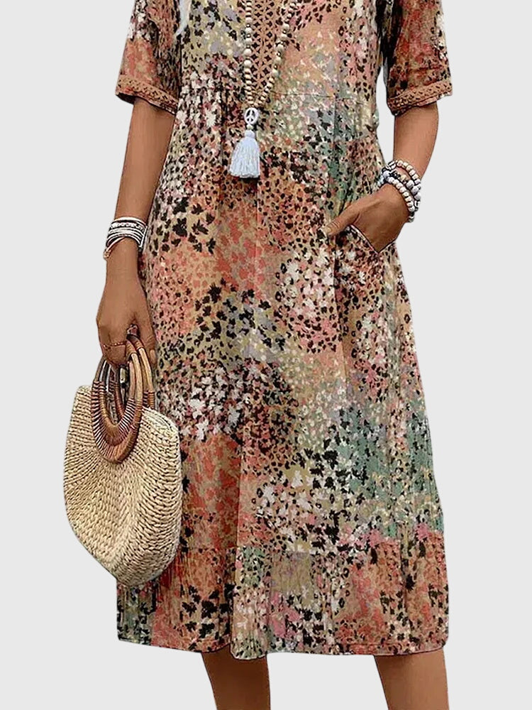 Effortless women's printed V-neck midi dress in a flowy fabric. Perfect casual summer or spring day wear fashion.
