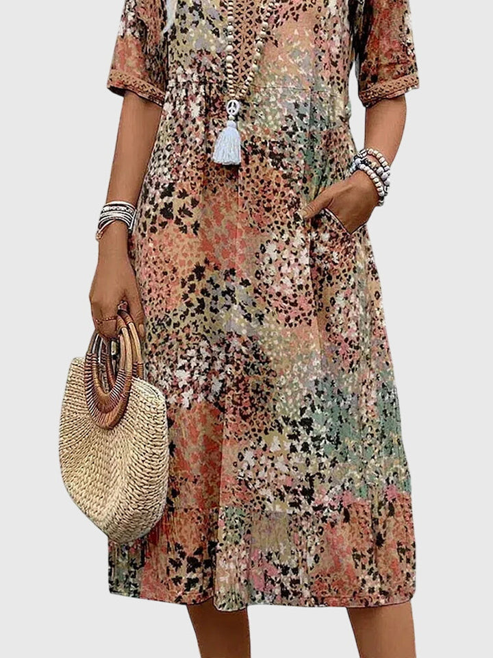 Effortless women's printed V-neck midi dress in a flowy fabric. Perfect casual summer or spring day wear fashion.