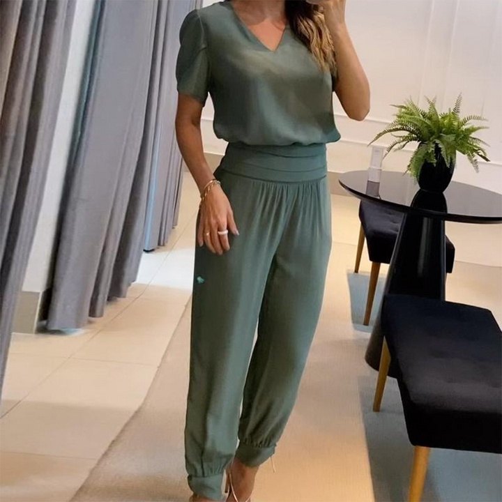 Elegant women's v-neck printed jumpsuit featuring wide legs and a flattering tie waist. Comfortable casual wear.