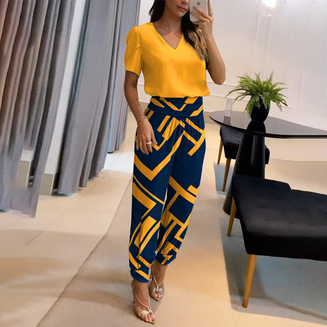 Vibrant printed wide leg jumpsuit for women with a chic v-neckline. Offers a relaxed, stylish summer outfit.