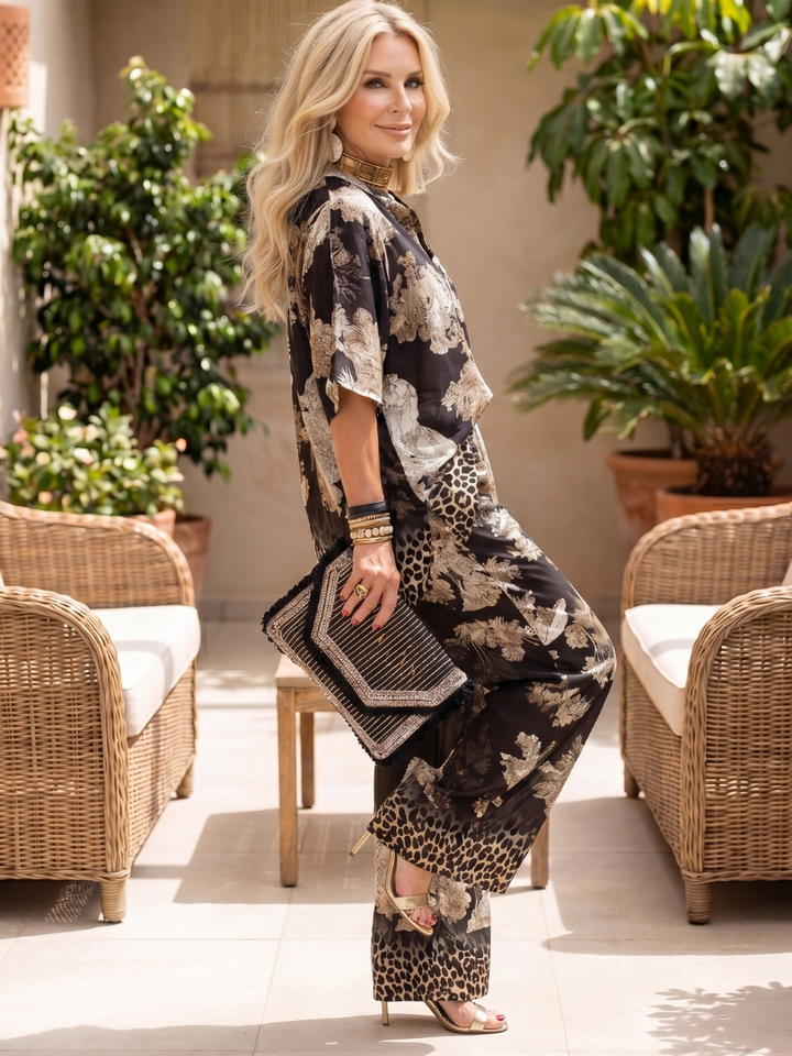 Chic women's two-piece co-ord set with a vibrant print, wide-leg trousers, and a flattering wrap top. Comfortable.