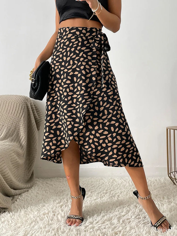 Black women's printed wrap tie midi skirt. Casual boho summer fashion with a flattering tie waist.
