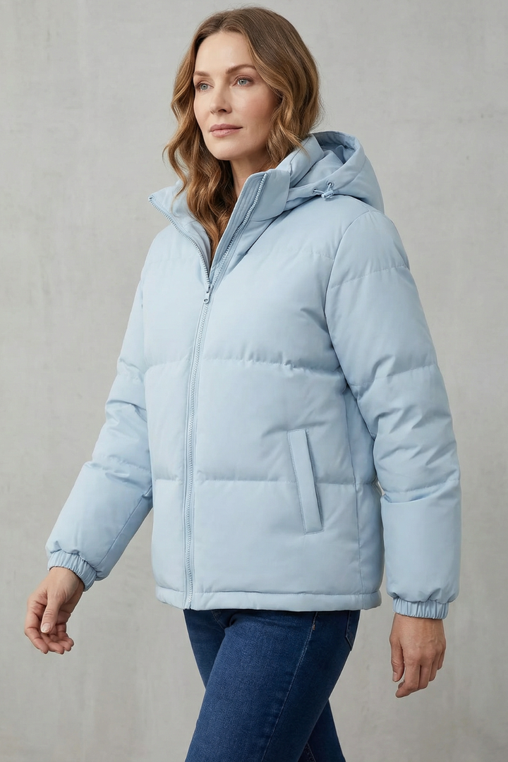 Stylish women's quilted puffer jacket with hood, offering versatile fashion for fall & winter.