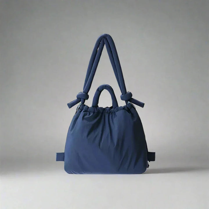 Women's lightweight quilted puffer tote. Stylish everyday bag with an eye-catching knot-detail strap.