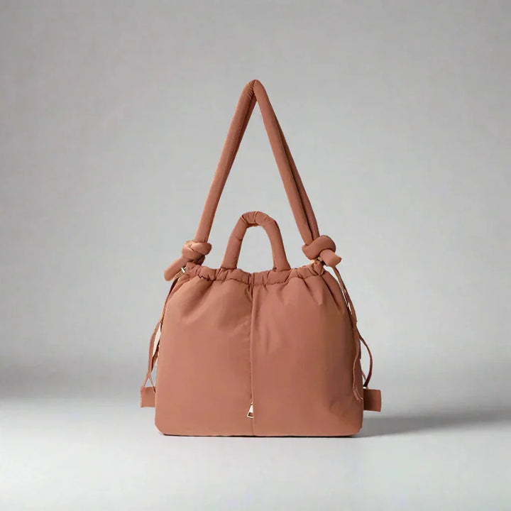 Versatile women's quilted puffer tote bag, designed with a chic knot-detail shoulder strap.