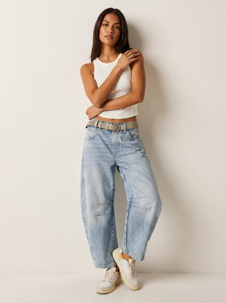 Woman wearing comfortable high-waist barrel leg denim jeans, showcasing relaxed fit and casual style.