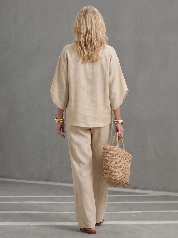 Elegant women's relaxed fit tunic and trouser set, featuring elbow sleeves and a stand collar.