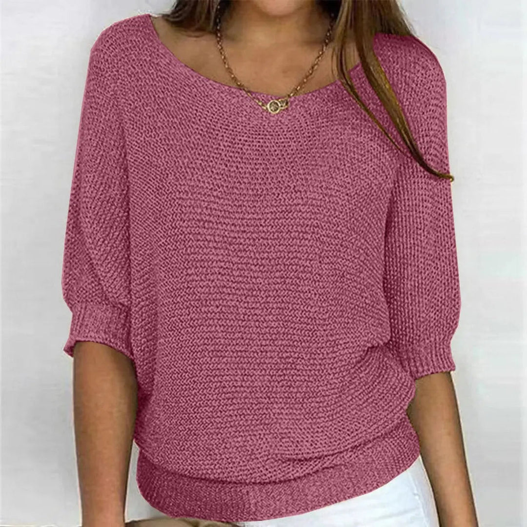 Side view of women's relaxed-fit batwing-sleeve sweater, highlighting comfortable drape & style.
