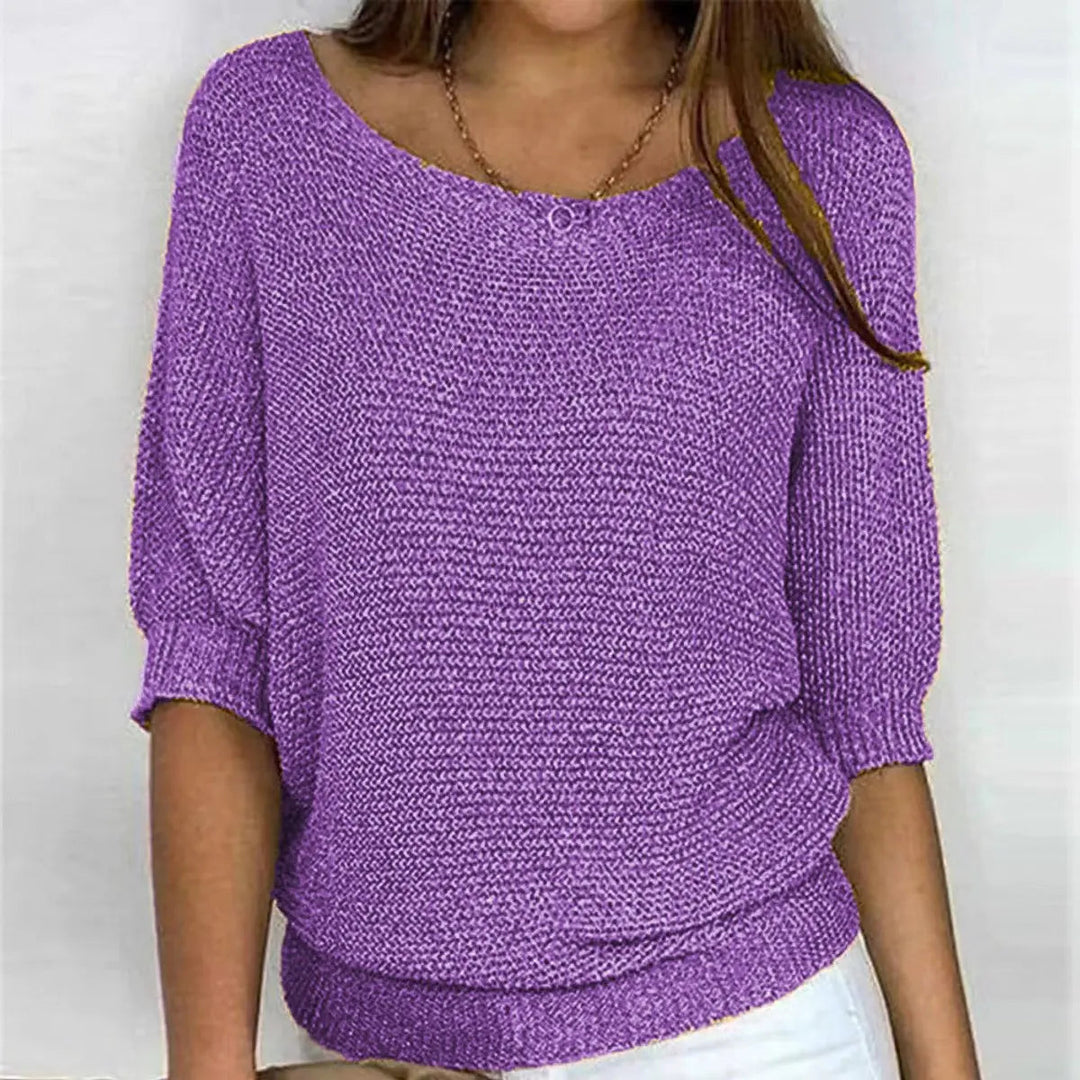 Women's batwing-sleeve sweater paired with jeans, showcasing a relaxed fit & casual style.