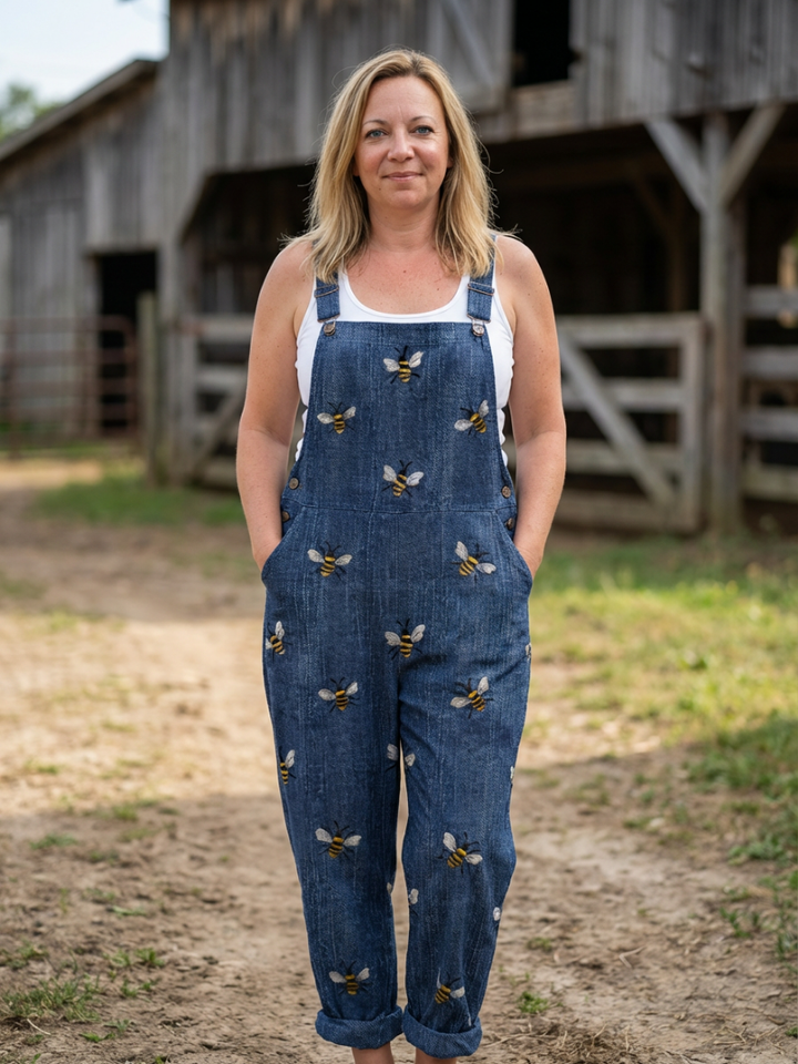 Women's relaxed fit blue jumpsuit with stylish all-over print, thin straps, perfect for casual summer wear.