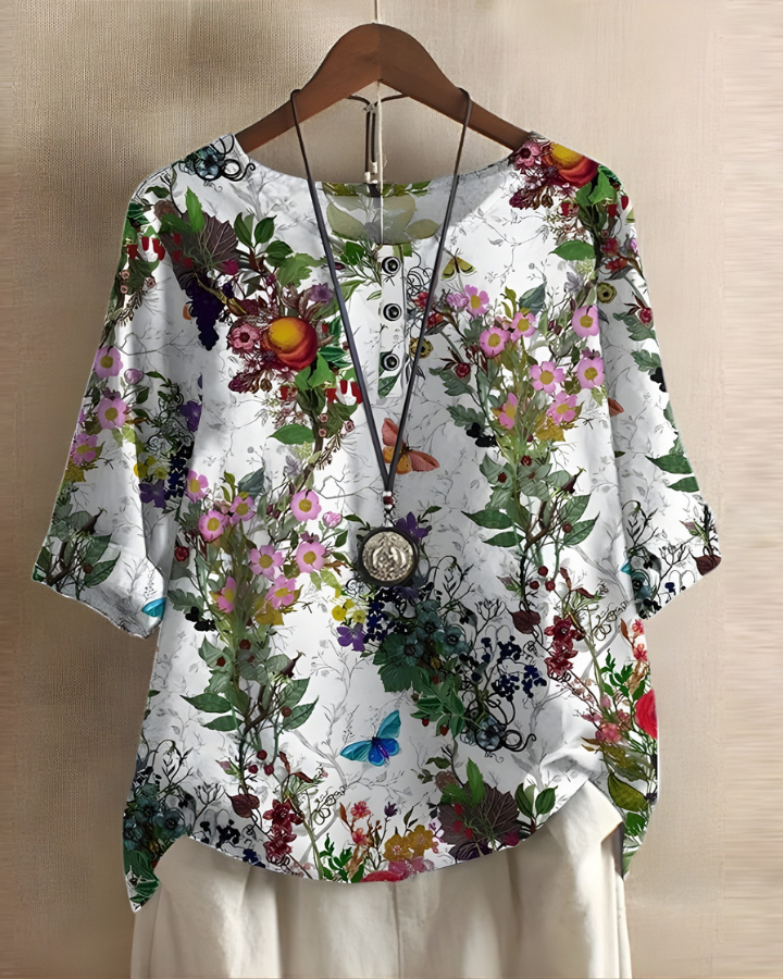 Stylish women's relaxed fit summer top, bohemian vibrant print. Comfortable short sleeve for casual wear.