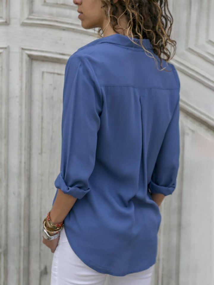 Stylish women's long sleeve button-down blouse, relaxed fit, featuring versatile roll-up sleeves. Perfect smart casual top.