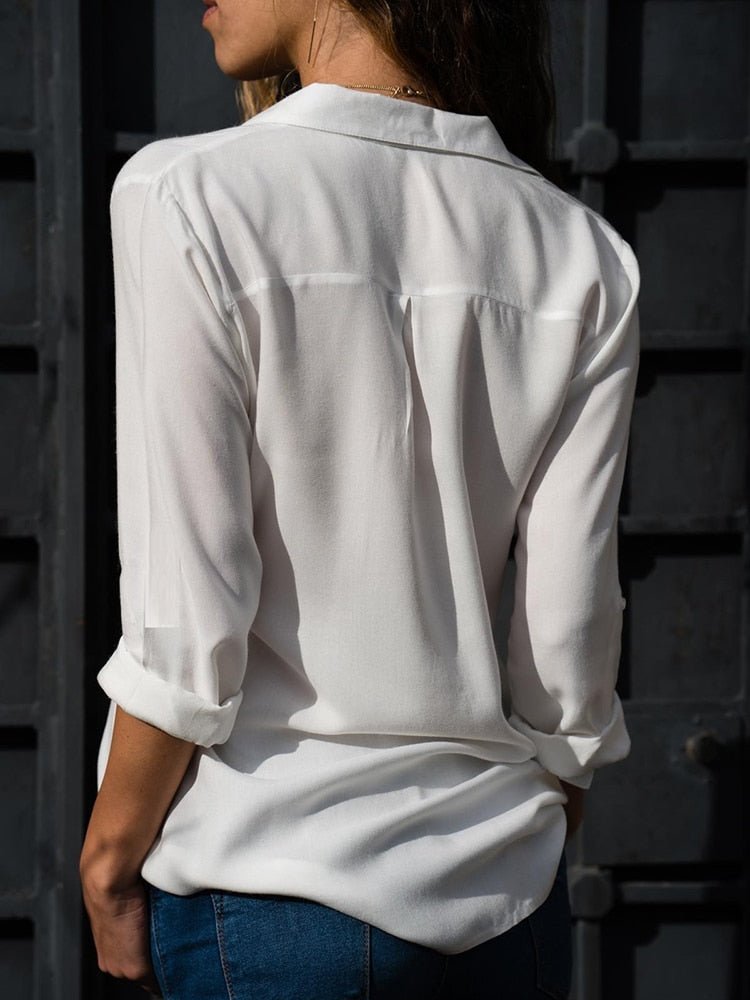Women's relaxed button-down blouse. Long sleeves with roll-up tabs. A versatile collared top for casual chic style.