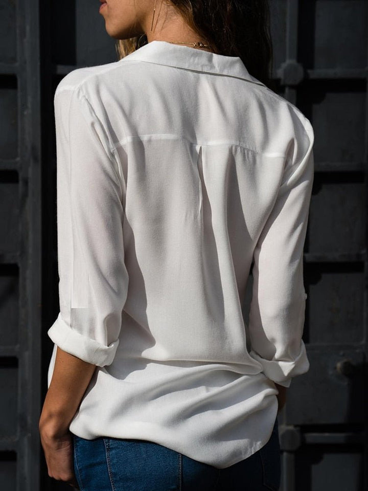 Women's relaxed button-down blouse. Long sleeves with roll-up tabs. A versatile collared top for casual chic style.