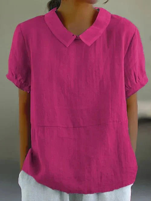 Women's relaxed-fit collared blouse with short sleeves, perfect for casual or work wear. Elegant and versatile.