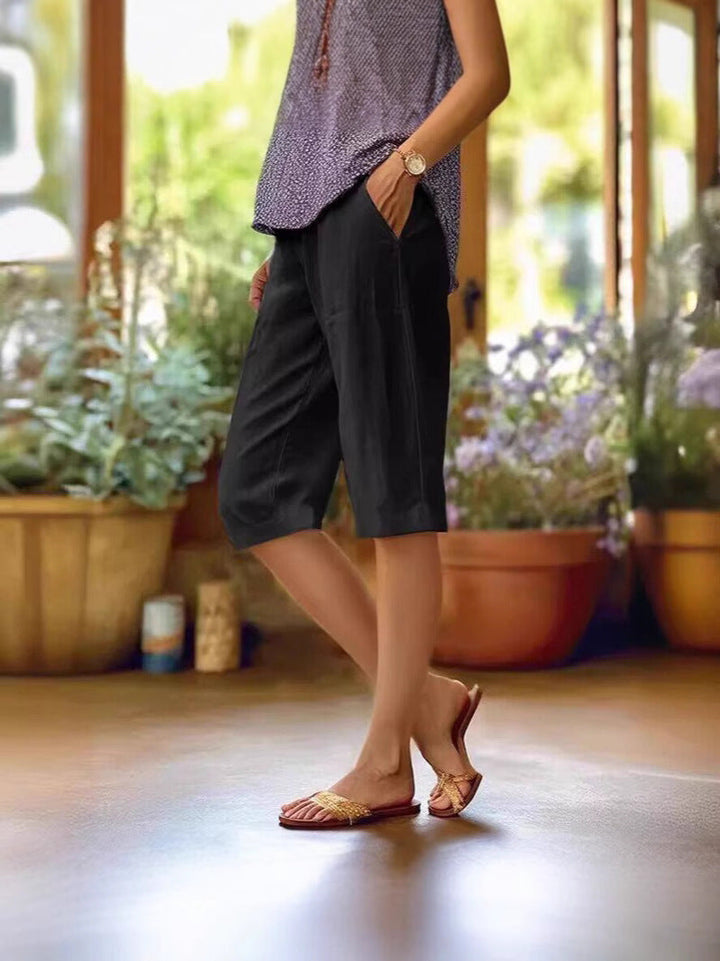 Practical women's knee-length pocket pants with a relaxed fit, offering comfort and style for casual summer days.