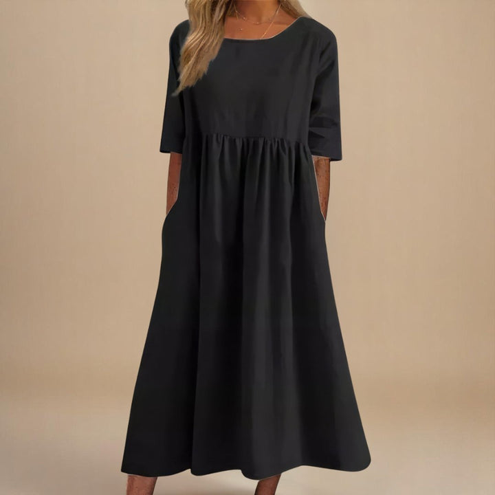 Stylish women's linen midi dress, ideal for spring & summer. Relaxed fit, half-sleeves, and gathered empire waist.