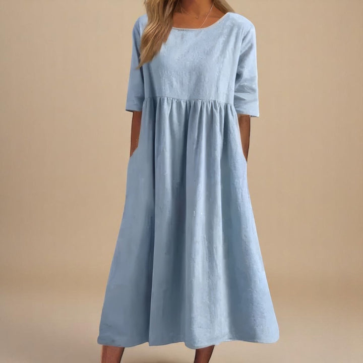 Lightweight linen midi dress for women. Relaxed fit, half-sleeves, and gathered waist offer comfort & casual style.