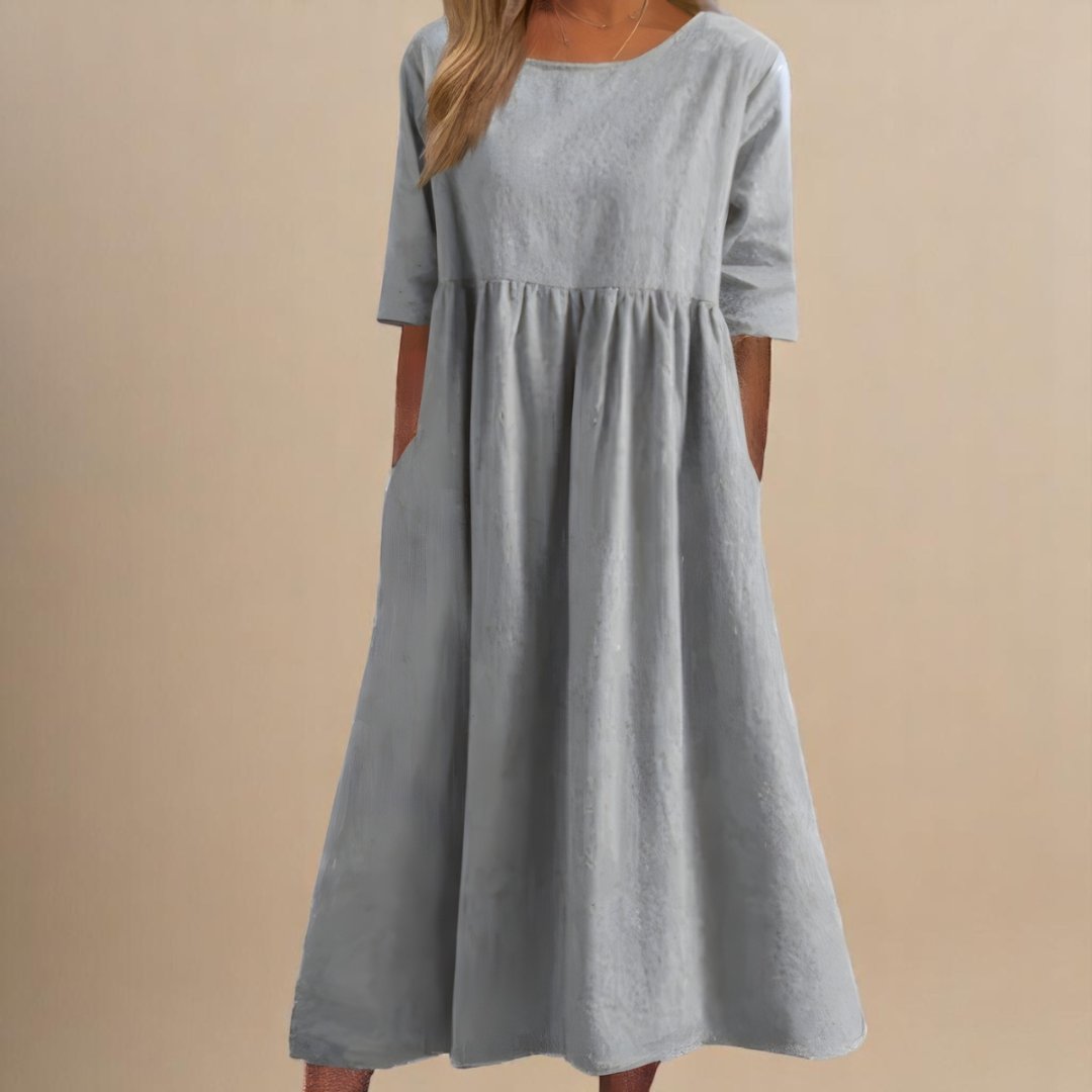 Women's relaxed fit linen midi dress. Half-sleeves and a gathered empire waist create a flattering, comfortable style.