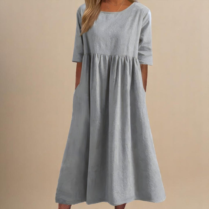 Women's relaxed fit linen midi dress. Half-sleeves and a gathered empire waist create a flattering, comfortable style.