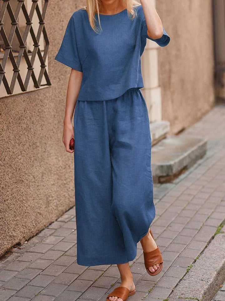 Plus size women's relaxed fit linen two-piece set. Casual summer outfit with a crew neck top & wide leg trousers.