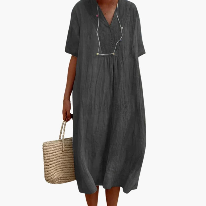 Versatile women's linen midi dress, v-neck and relaxed fit for casual or elegant summer day wear.