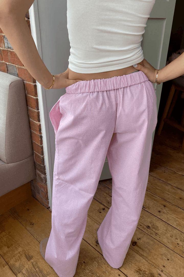 Woman relaxing in comfortable, relaxed fit lounge pants, ideal for home, casual wear, or light athleisure activities.