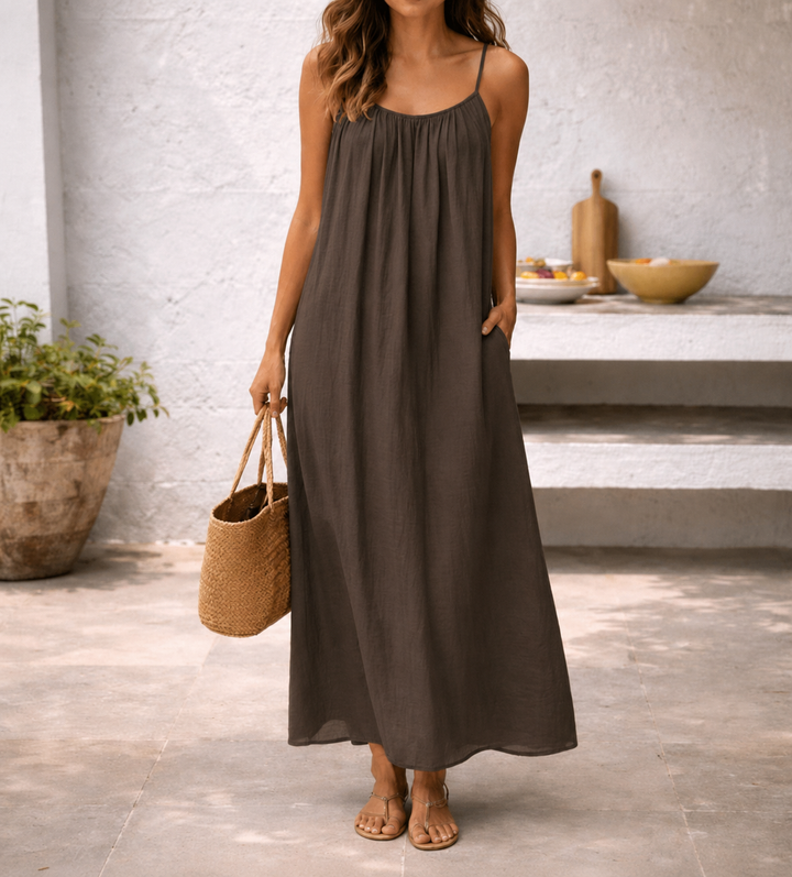 Women's relaxed fit maxi beach dress with adjustable straps & pockets, perfect for summer vacations.