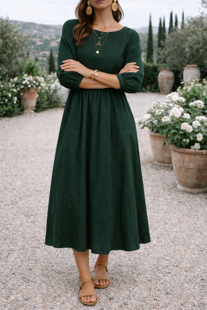 Flowy women's smock maxi dress, comfortable and versatile with 3/4 sleeves, round neck, and pockets.