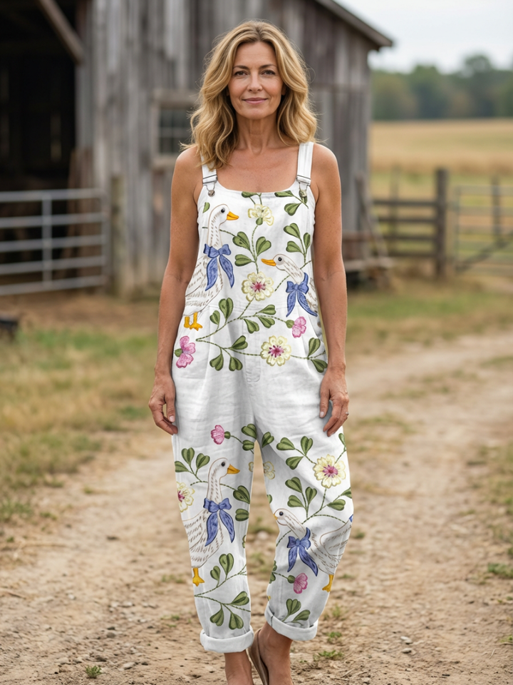 Women's relaxed fit peace strap jumpsuit with elegant botanical print, perfect for summer casual wear.
