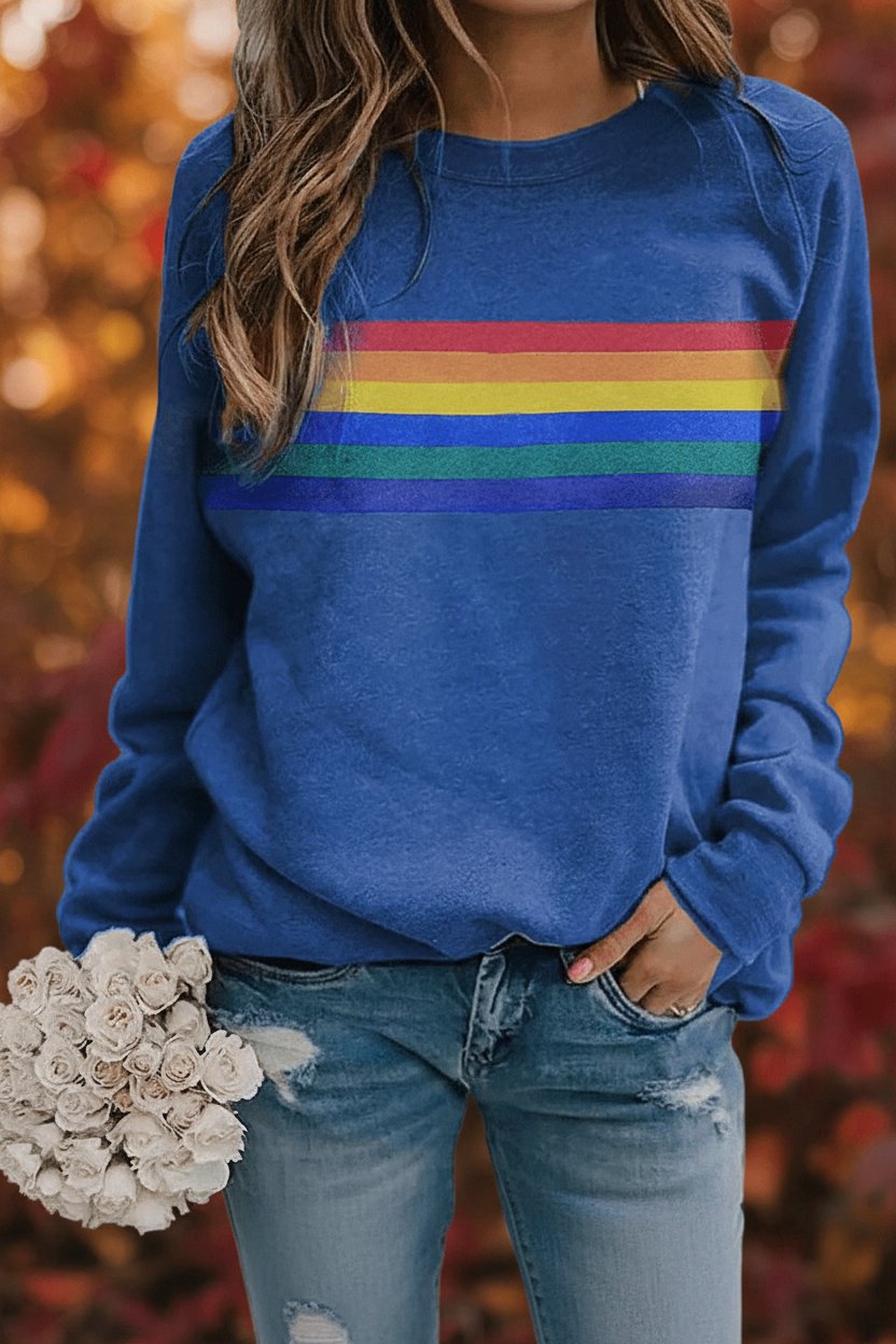 Vintage-inspired rainbow striped women's jumper, relaxed fit, crew neck. Everyday casual wear.