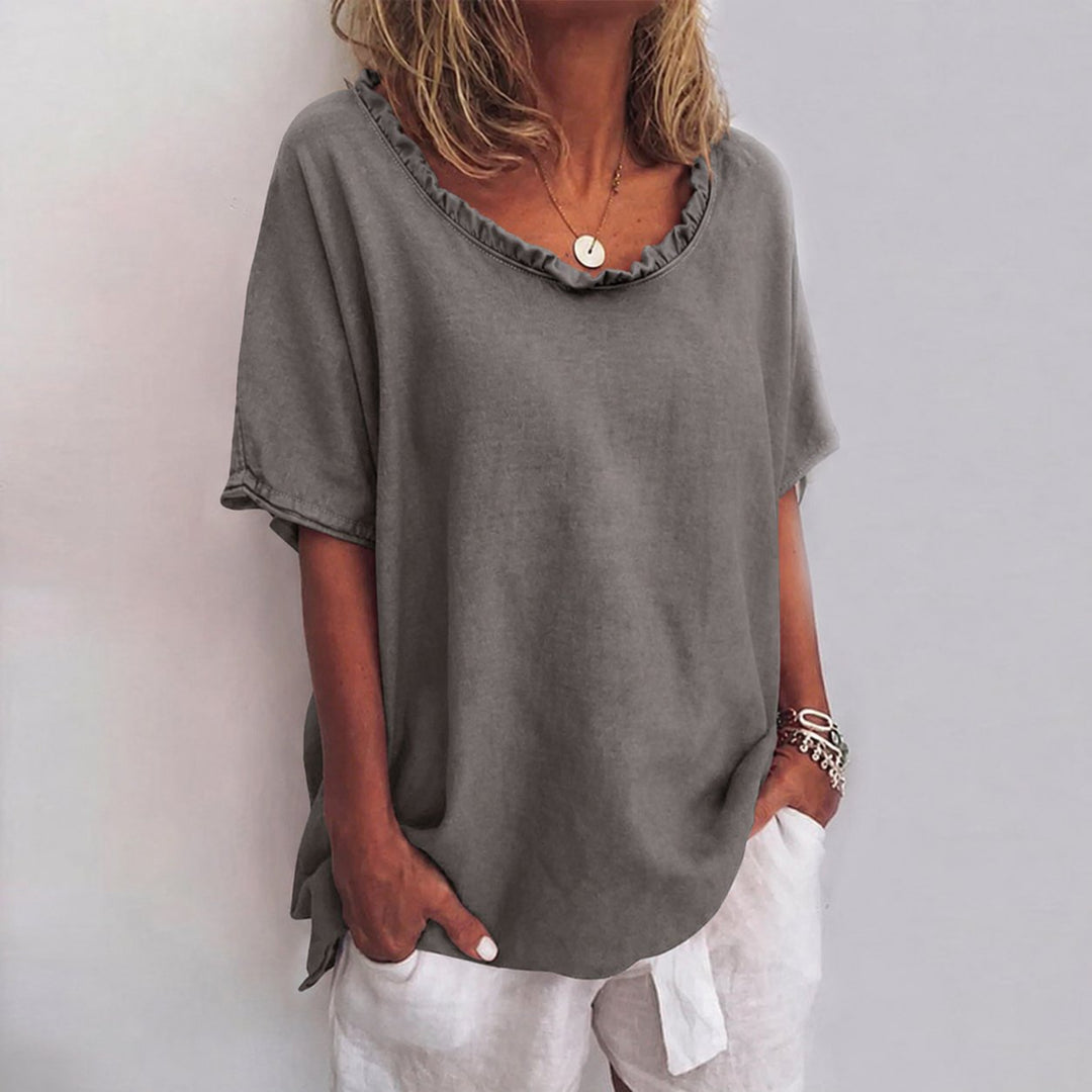 Loose-fit women's short-sleeve blouse with a ruffle neck, perfect for versatile summer and daywear.