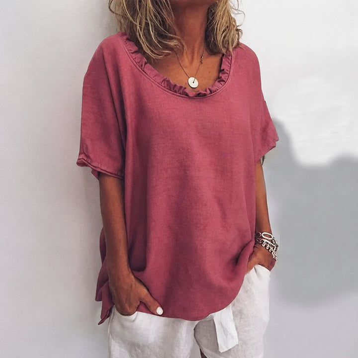 Relaxed-fit women's short-sleeve blouse, features a ruffle neck, great for comfortable everyday style.