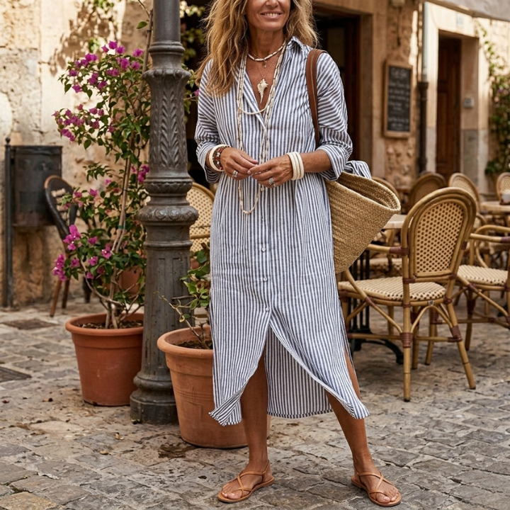 Detail of a women's relaxed striped shirt dress, featuring button front closure & comfortable fabric for daywear.