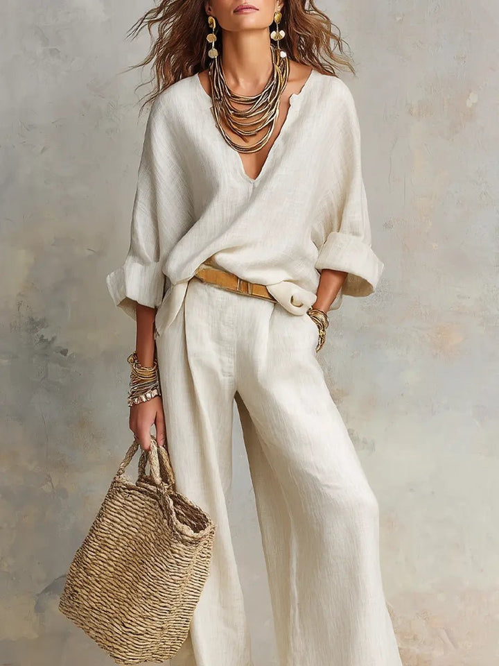 Stylish women's two-piece resort wear for relaxed summer days or elegant travel. Features a V-neck top & flowing pants.