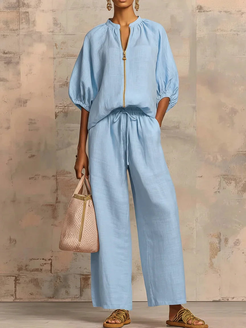 Women's two-piece set featuring a relaxed button-up shirt with long sleeves & comfortable wide-leg trousers.