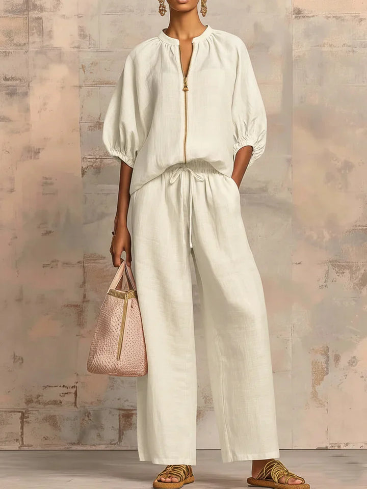 Stylish women's relaxed two-piece outfit with a button-front shirt and flowy wide-leg trousers, great for summer.