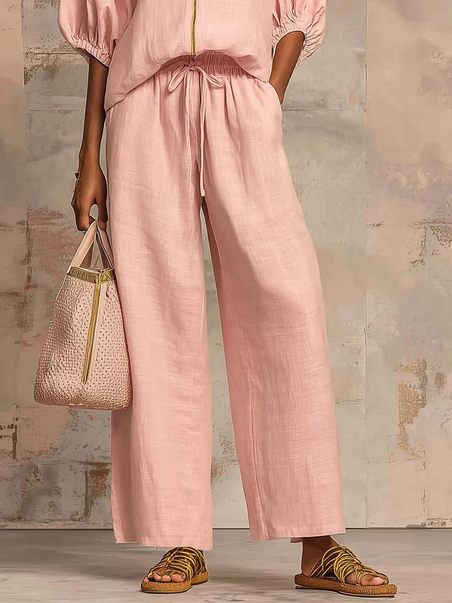 Fashionable women's relaxed fit two-piece set, featuring a button-up shirt and trendy wide-leg trousers for comfort.