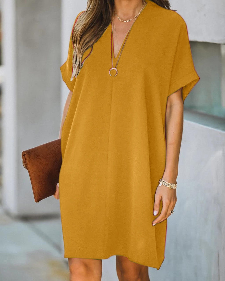 Versatile women's V-neck tunic dress, ideal for beach, day wear, or casual summer outings. Short sleeve.