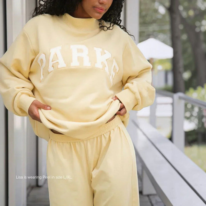 Cozy women's relaxed fit varsity sweater, perfect for casual everyday wear.