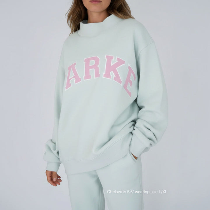 Casual oversized women's varsity hoodie, relaxed fit for cozy loungewear.