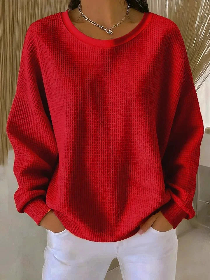 Comfortable women's waffle knit sweater. Relaxed fit, long sleeve, perfect for winter fashion.