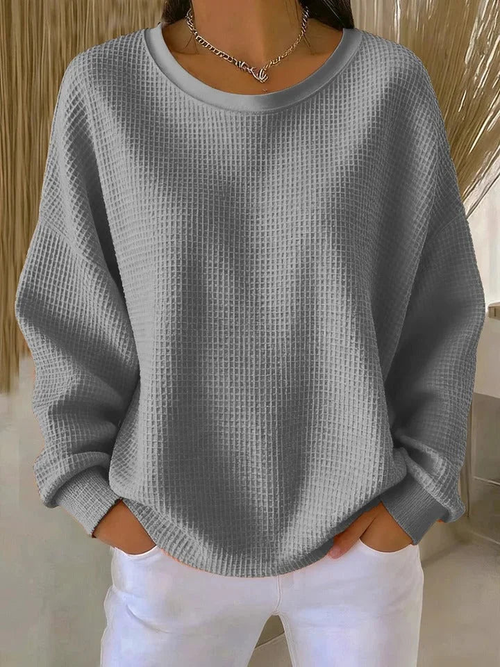 Stylish women's long sleeve waffle knit sweater. Relaxed fit knit top, ideal for cozy everyday wear.
