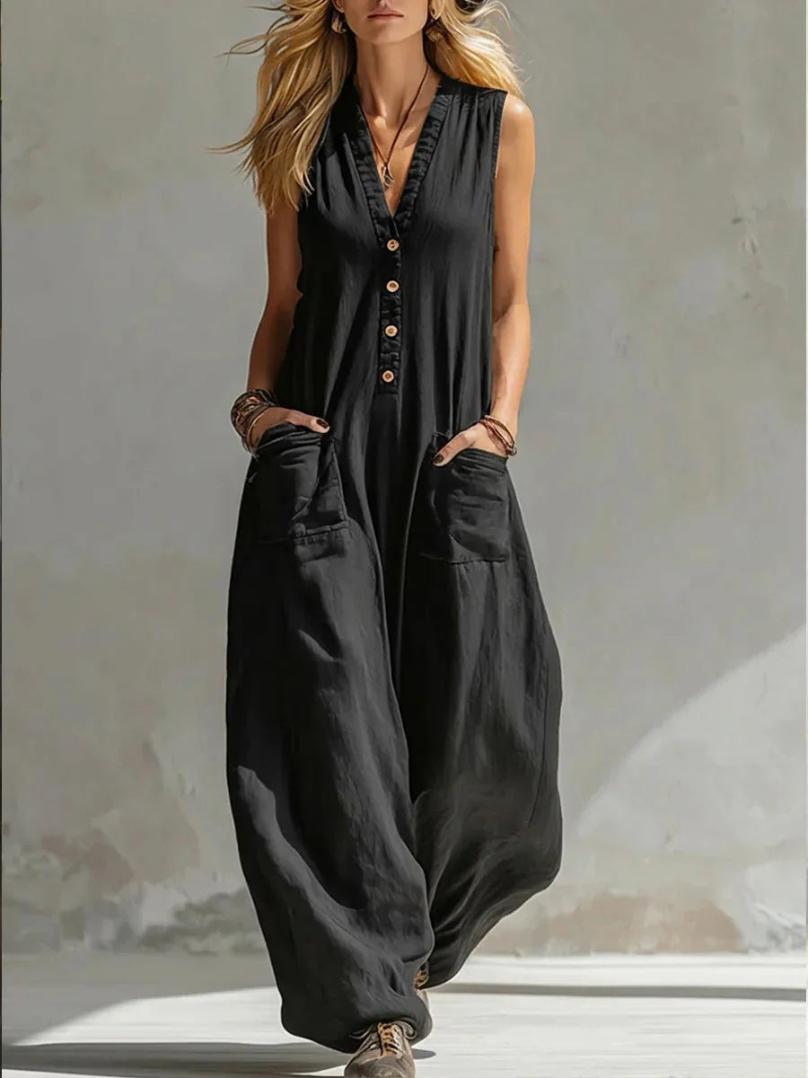 Relaxed wide leg sleeveless jumpsuit for women. Button front, pocketed, casual summer fashion, holiday attire.