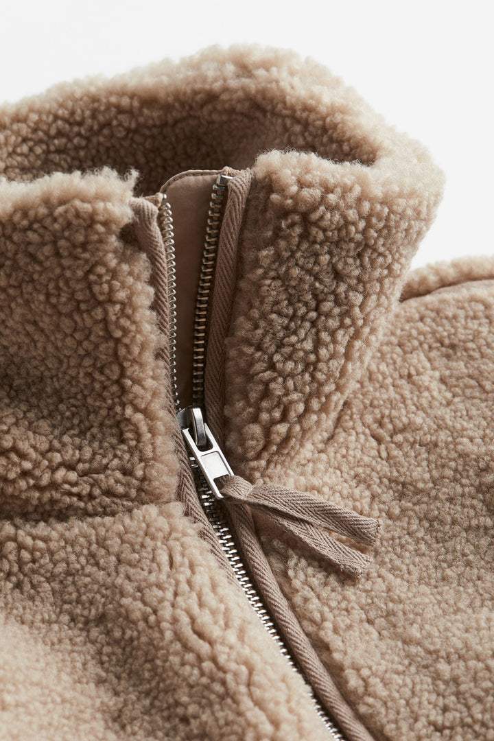 Stylish women's relaxed fit zip-up jacket, high neck design. Cozy and warm outerwear for cold weather.