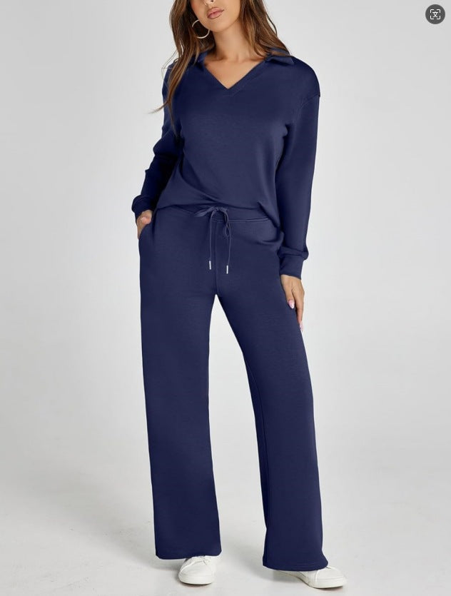 Model walking in a women's versatile two-piece tracksuit. Zip-neck top & wide-leg pants.