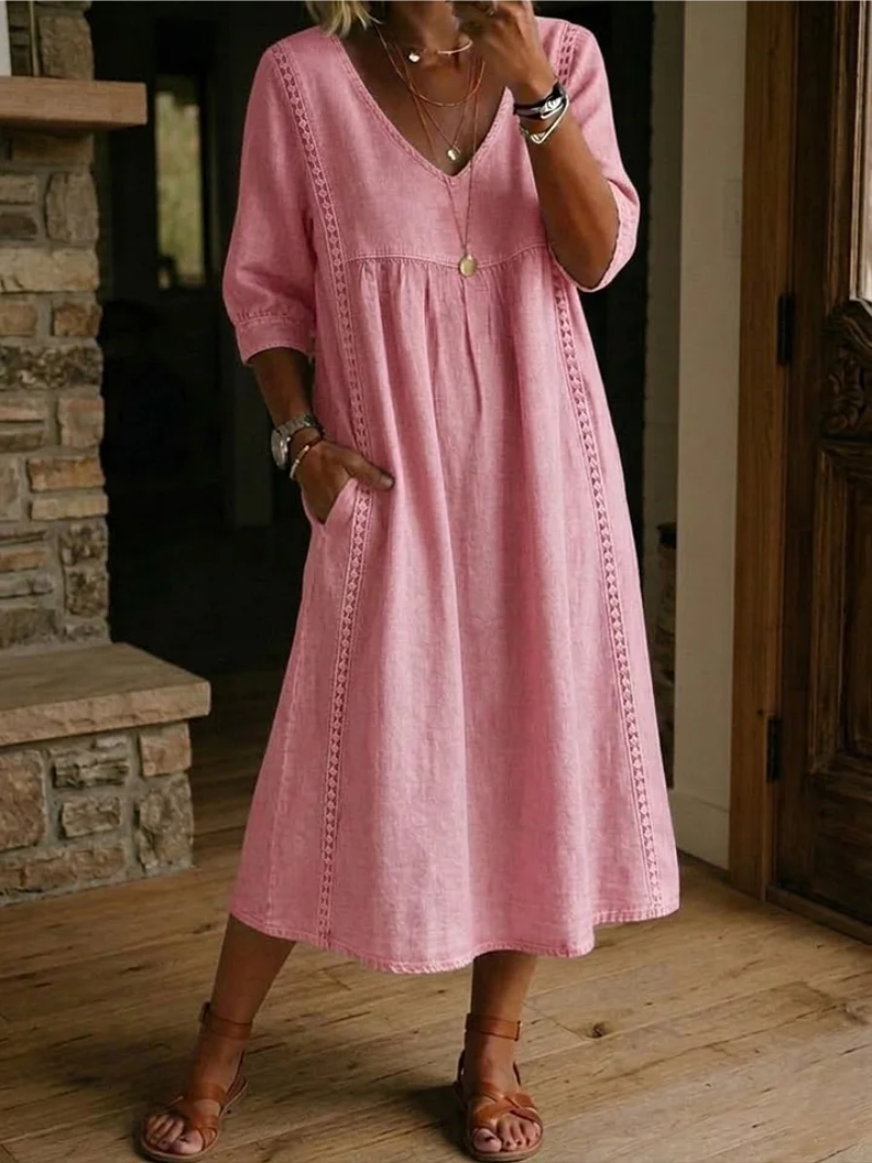 Women's relaxed V-neck midi dress for effortless daily style. Comfortable, flowy design with pockets, perfect for spring/summer.